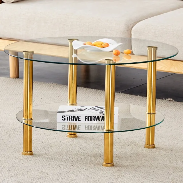 intebiki Moderne glazen salontafel met twee niveaus - goudkleurige metalen poten, stabiel en ruim, licht en luxueus design. De metallic glans en de reflecties in het glas vormen een perfecte combinatie voor interieurs met ingetogen luxe. Goud, transparant